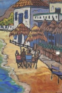 A colourful sceneof a table of people on a Greek beach with white houses in the background