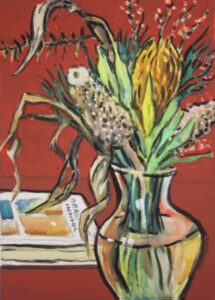 Flowers in a glass vase in reds and yellows